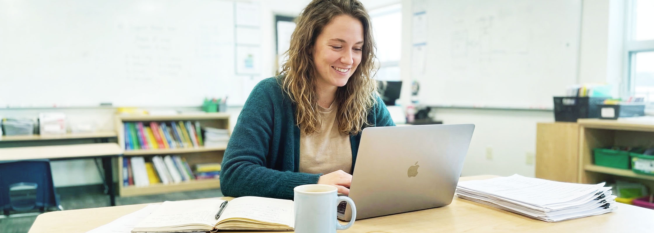 Teacher and SENDCo looking at a tablet together in a school corridor